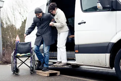 Senior entering a vehicle with assistance, representing Thrive at Home Network's senior transportation services for errands, appointments, and daily living support.