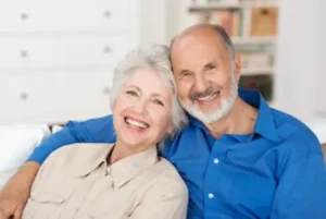 Happy retired couple smiling together, representing financial security and successful retirement planning with local providers found with Thrive at Home Network.