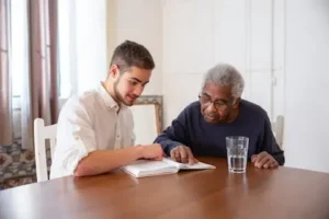 Senior engaging in meaningful learning with a younger mentor, highlighting the importance of finding purpose in retirement with Thrive at Home Network