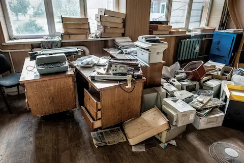 Office cluttered with boxes and junk.